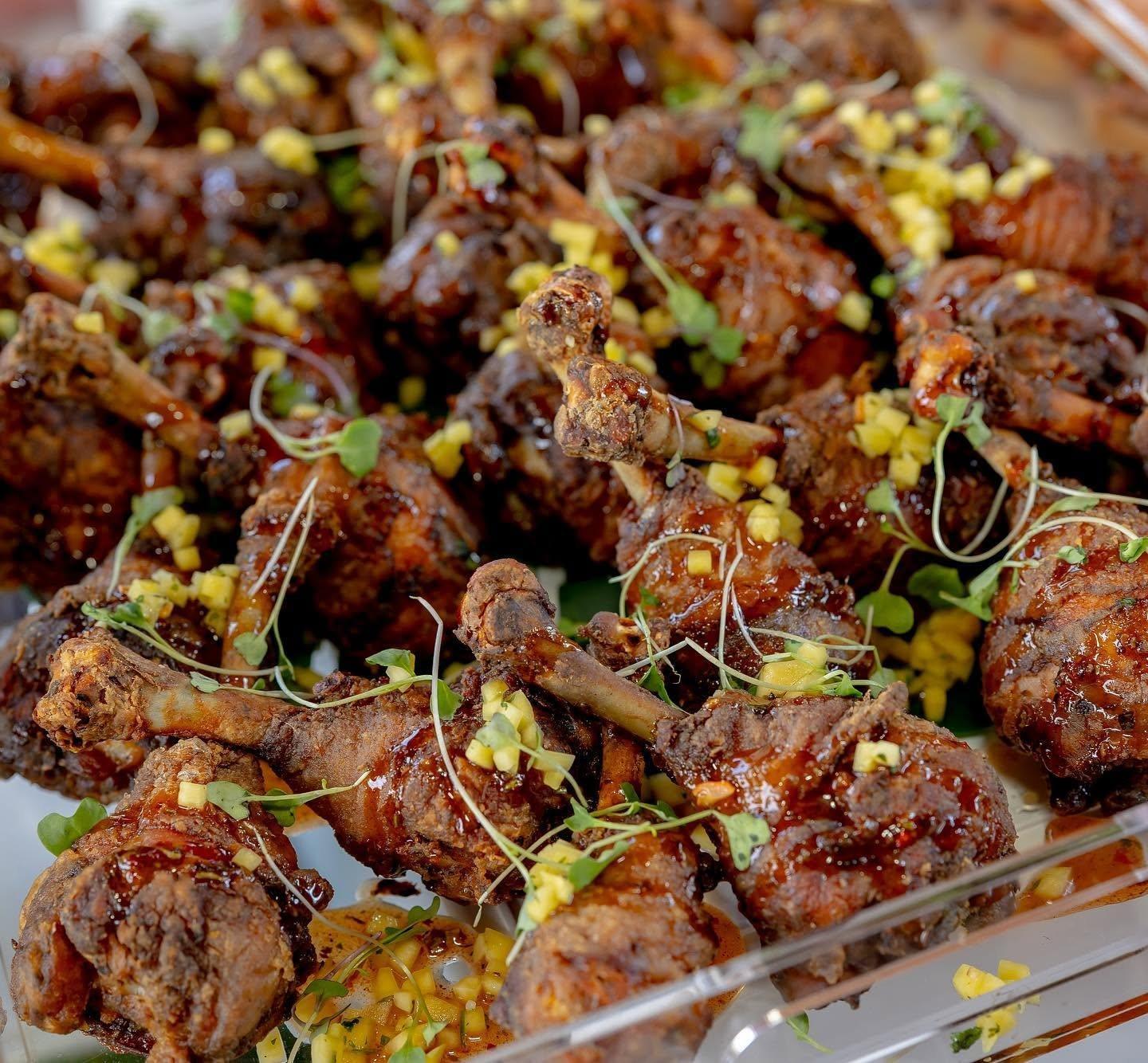 Glazed chicken lollipops with pineapple and microgreens